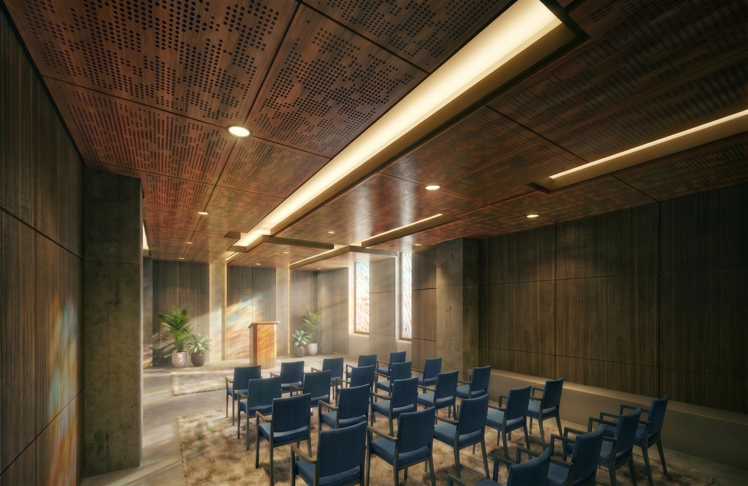 “Interior view of the non‑denominational chapel at Austin State Hospital designed with architecture+, showing rows of blue upholstered chairs facing a wooden podium set against tall stained‑glass windows. Warm wood wall and ceiling panels, perforated acoustic detailing, recessed lighting, and potted greenery create a serene, human‑scaled sanctuary that supports emotional respite and quiet reflection within a behavioral health environment.